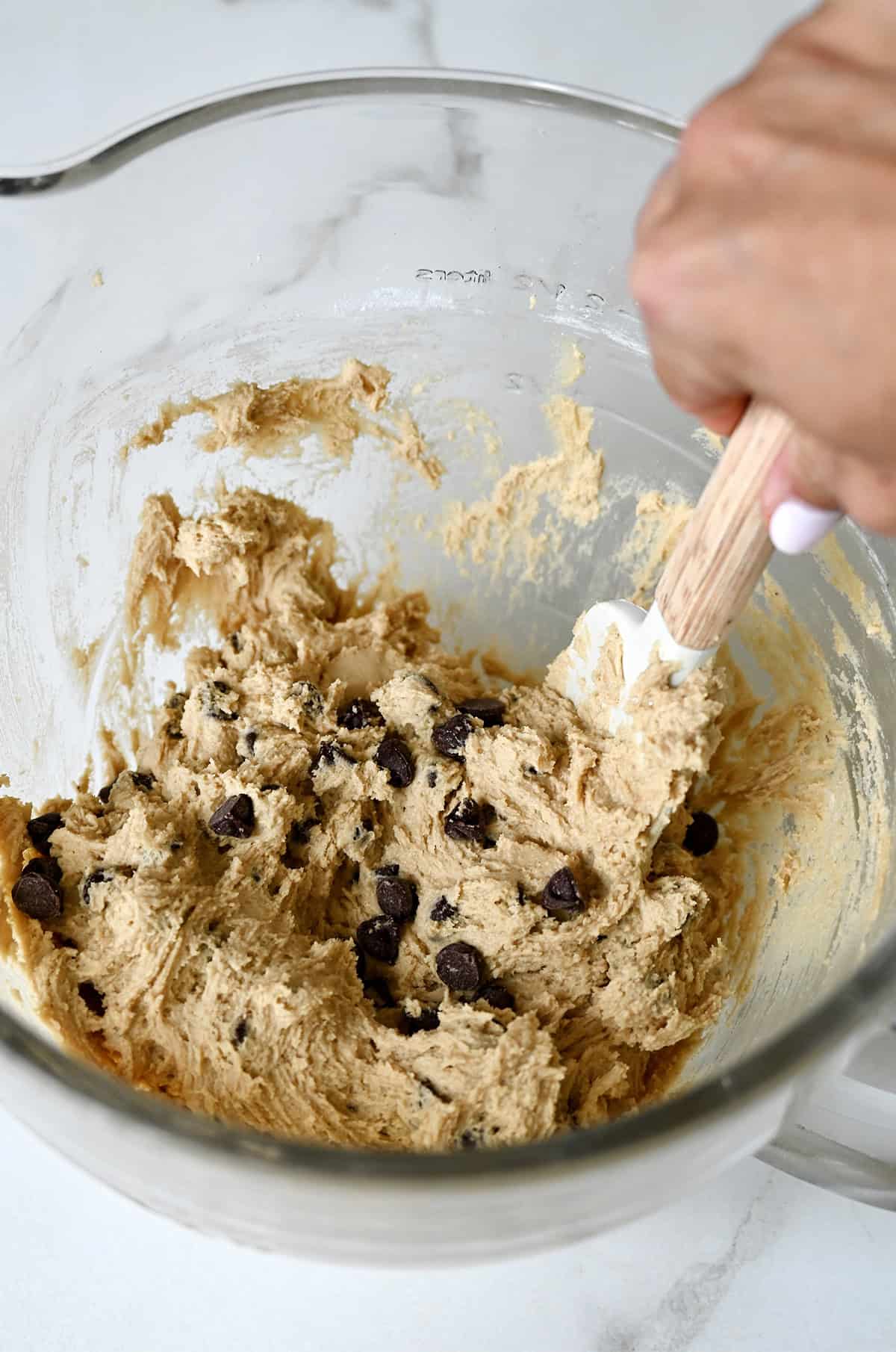 Chocolate chip cookie cake dough in a large mixing bowl.