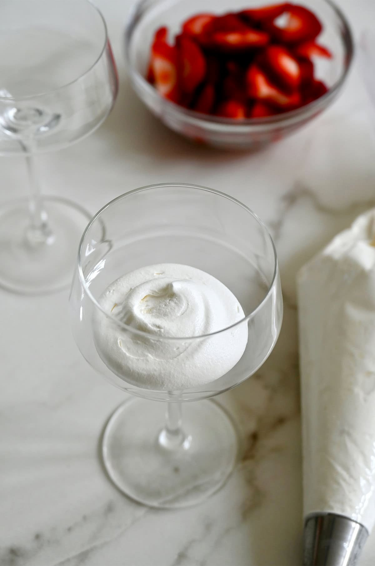 Whipped cream in the bottom of a cocktail glass.