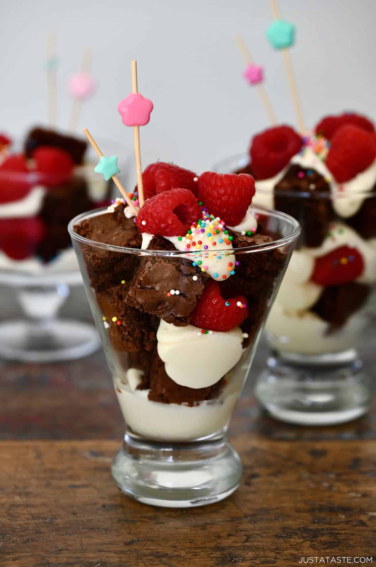 Brownie cocktail cakes with sprinkles in individual serving glasses.