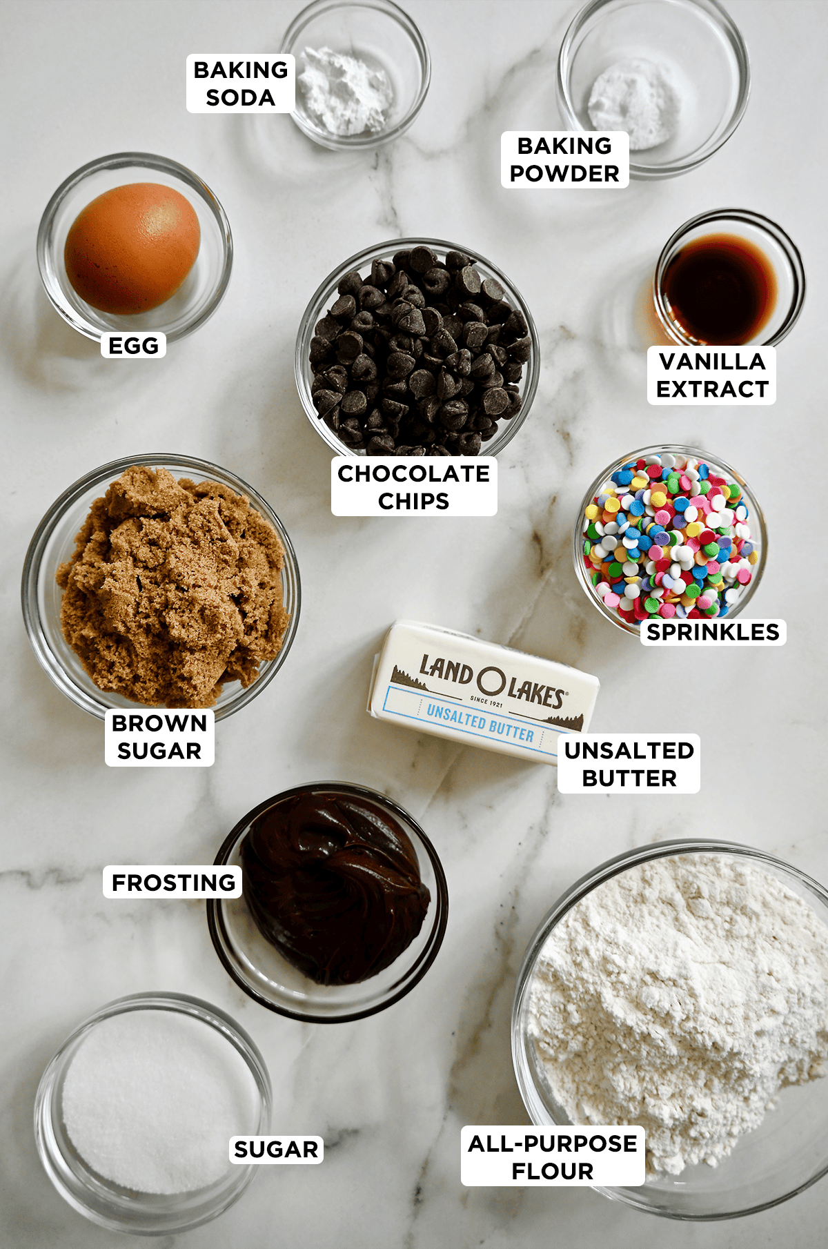 Ingredients to make cookie cocktail cakes in various sizes of prep bowls.