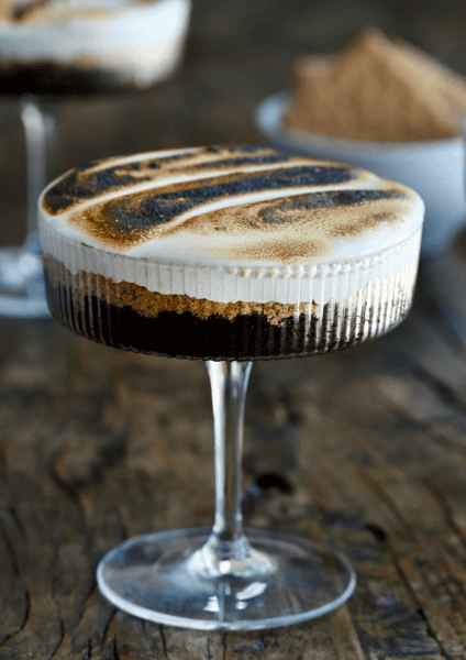 S'mores cake in a cocktail glass with toasted marshmallow fluff.