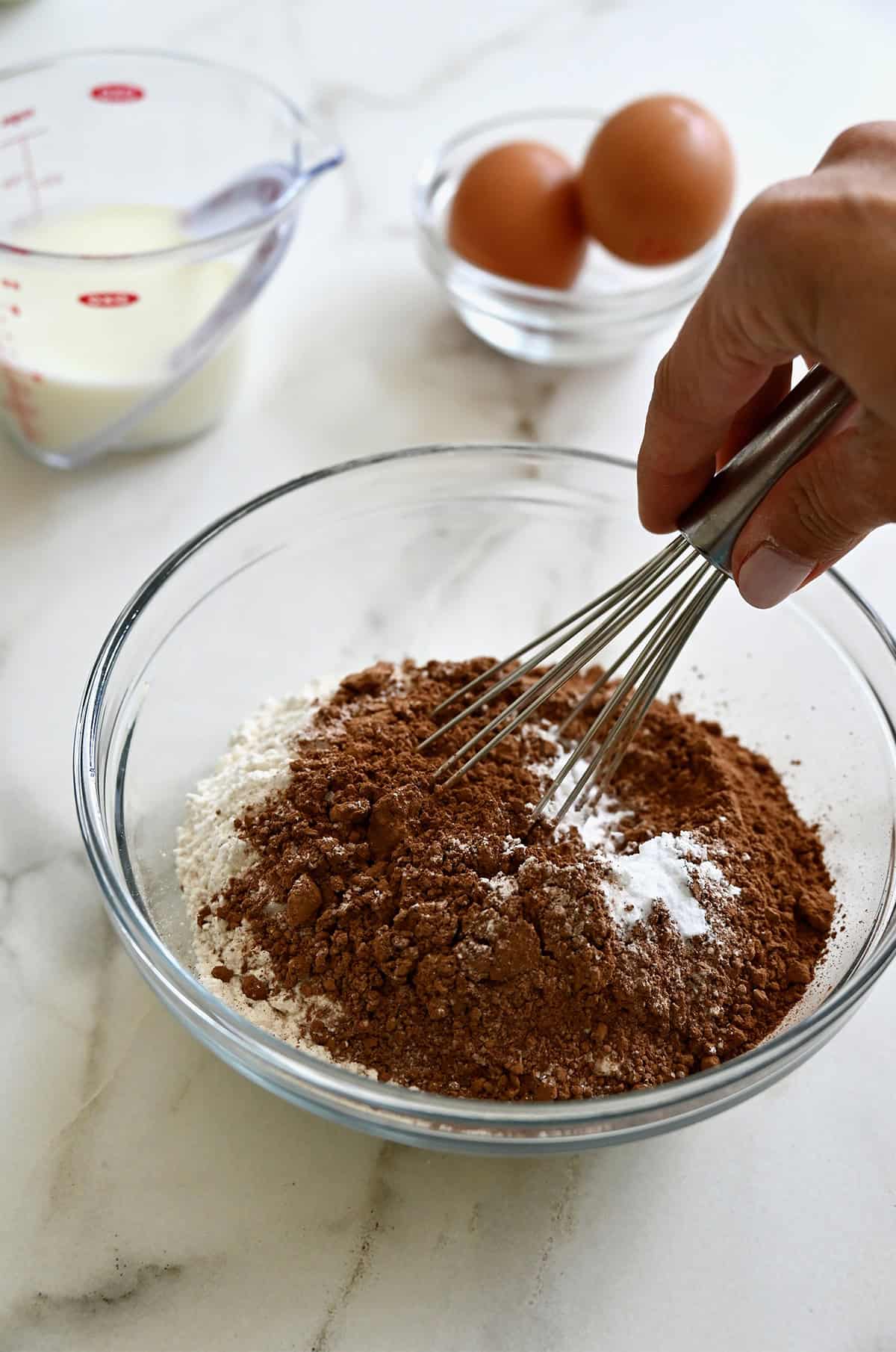 Dry ingredients for chocolate dot cake in a mixing bowl.