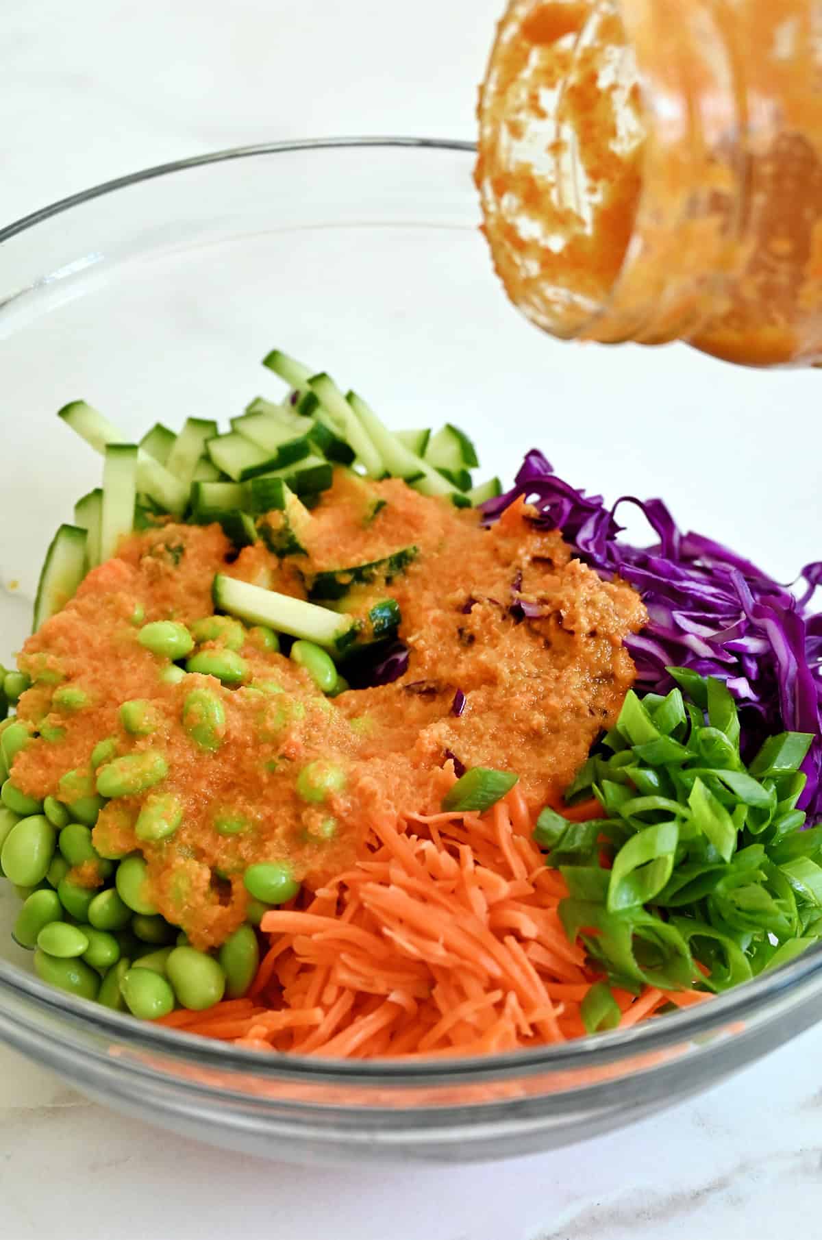 Crunchy cabbage salad topped with carrot-ginger dressing.