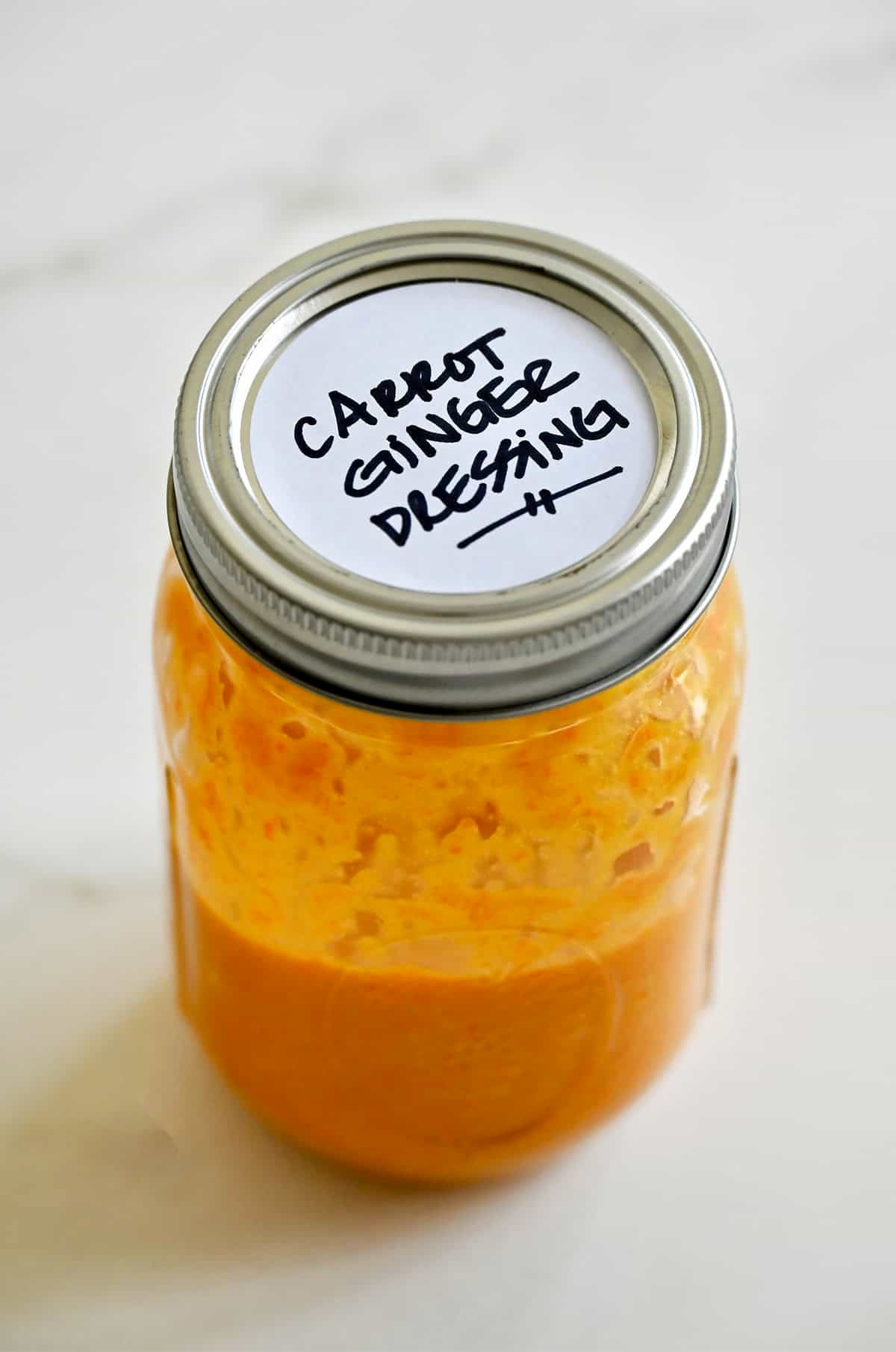 Homemade carrot-ginger dressing in a mason jar.