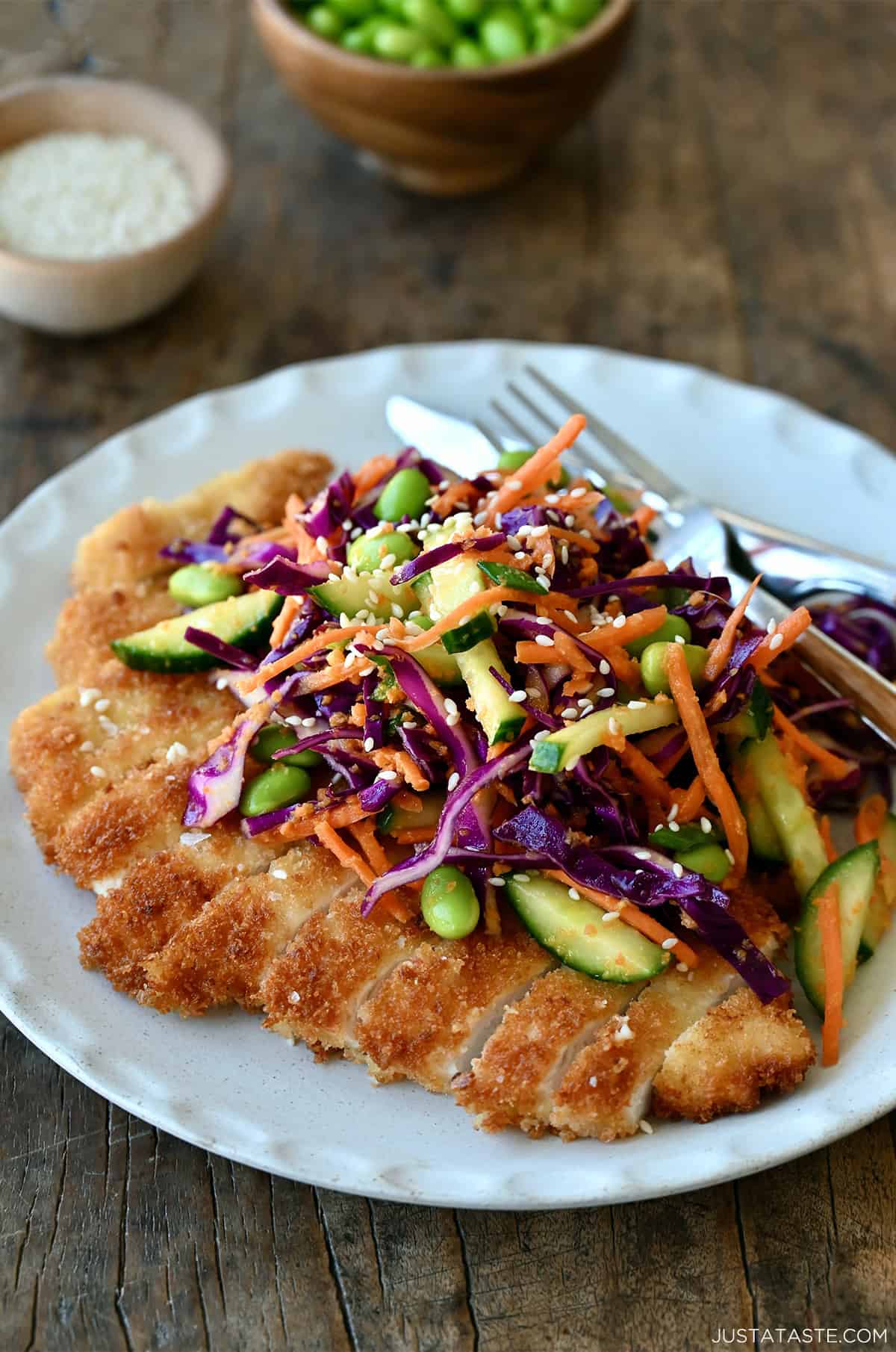 Chicken katsu topped with an Asian-inspired salad tossed with a carrot-ginger dressing.