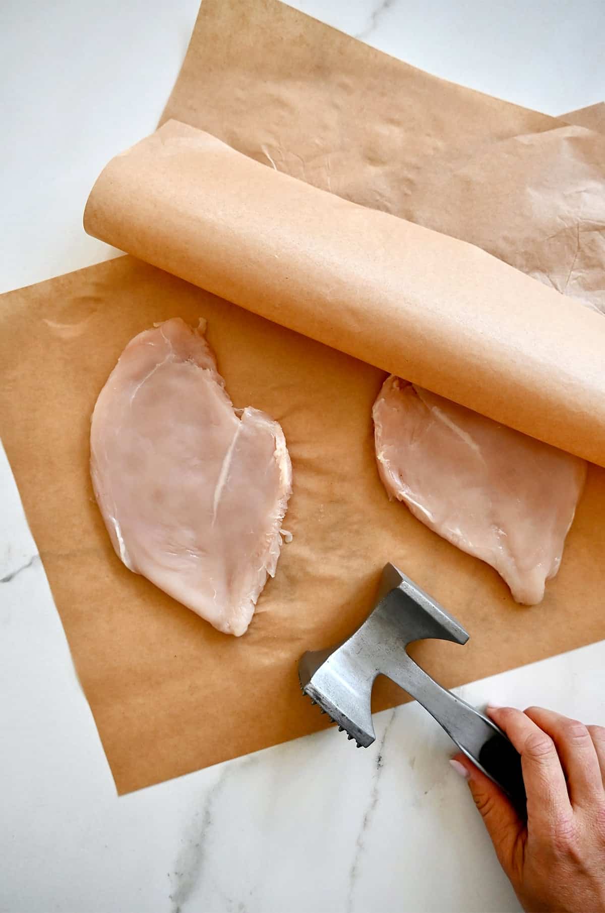 Pound chicken breasts into a thin, 1/2-inch-thick layer between two sheets of parchment paper with a meat mallet.