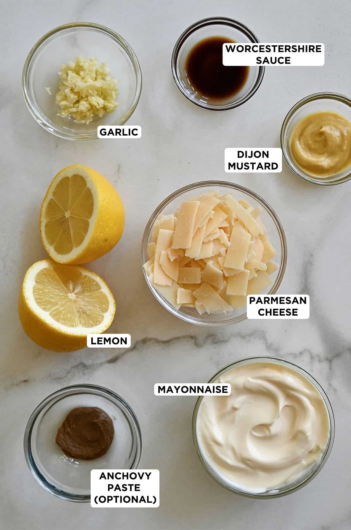 All the ingredients needed to make Caesar salad dressing.