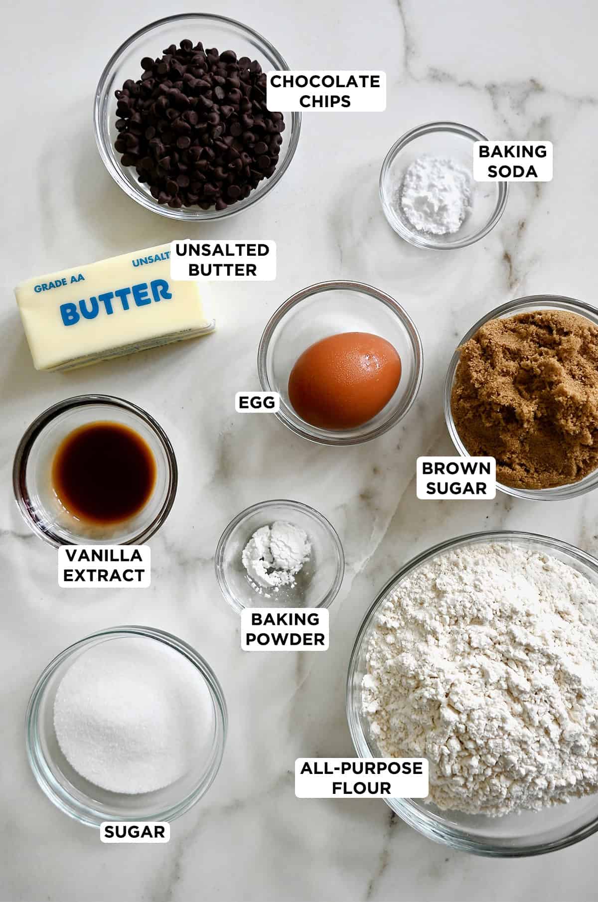 Ingredients to make cookie croutons with mini chocolate chips in various sizes of prep bowls.
