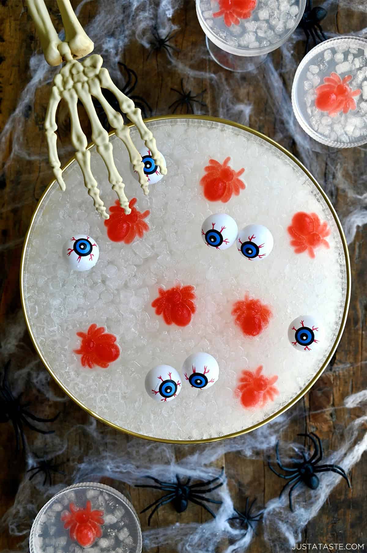 Spooky Halloween punch with plastic eyes and bloody spider ice cubes in a large punch bowl.