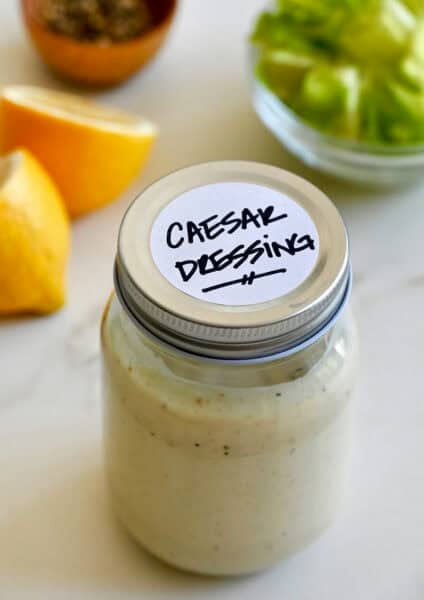A mason jar containing homemade Caesar dressing.