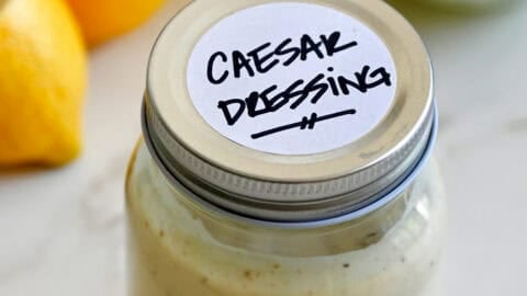 A mason jar containing homemade Caesar dressing.