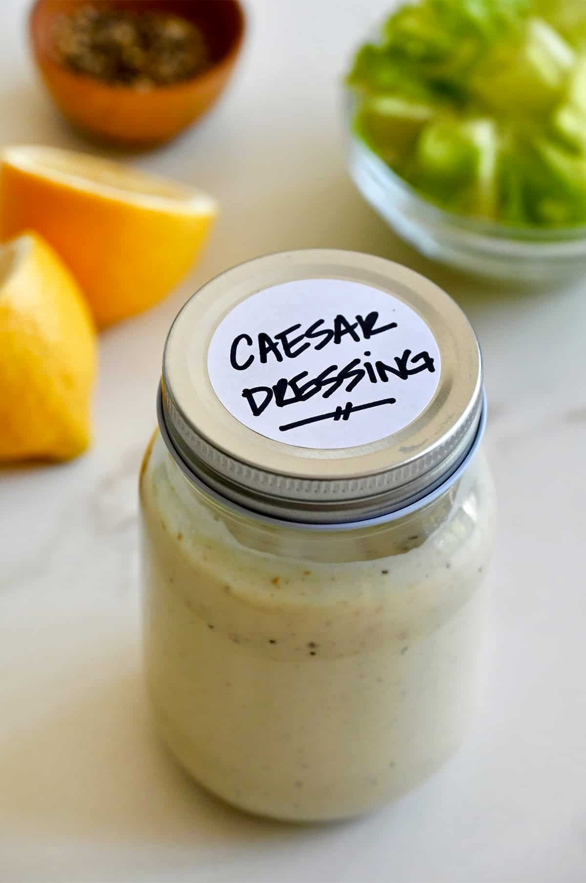 A mason jar containing homemade Caesar dressing.