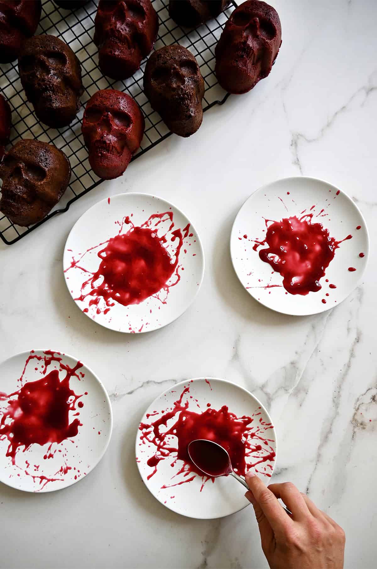 Raspberry sauce splattered on plates to look like blood.
