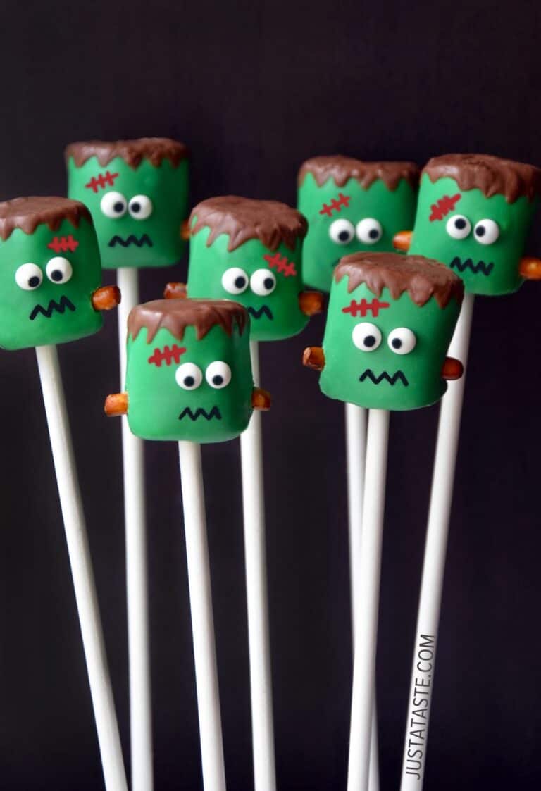 Frankenstein marshmallow pops on white lollipop sticks.