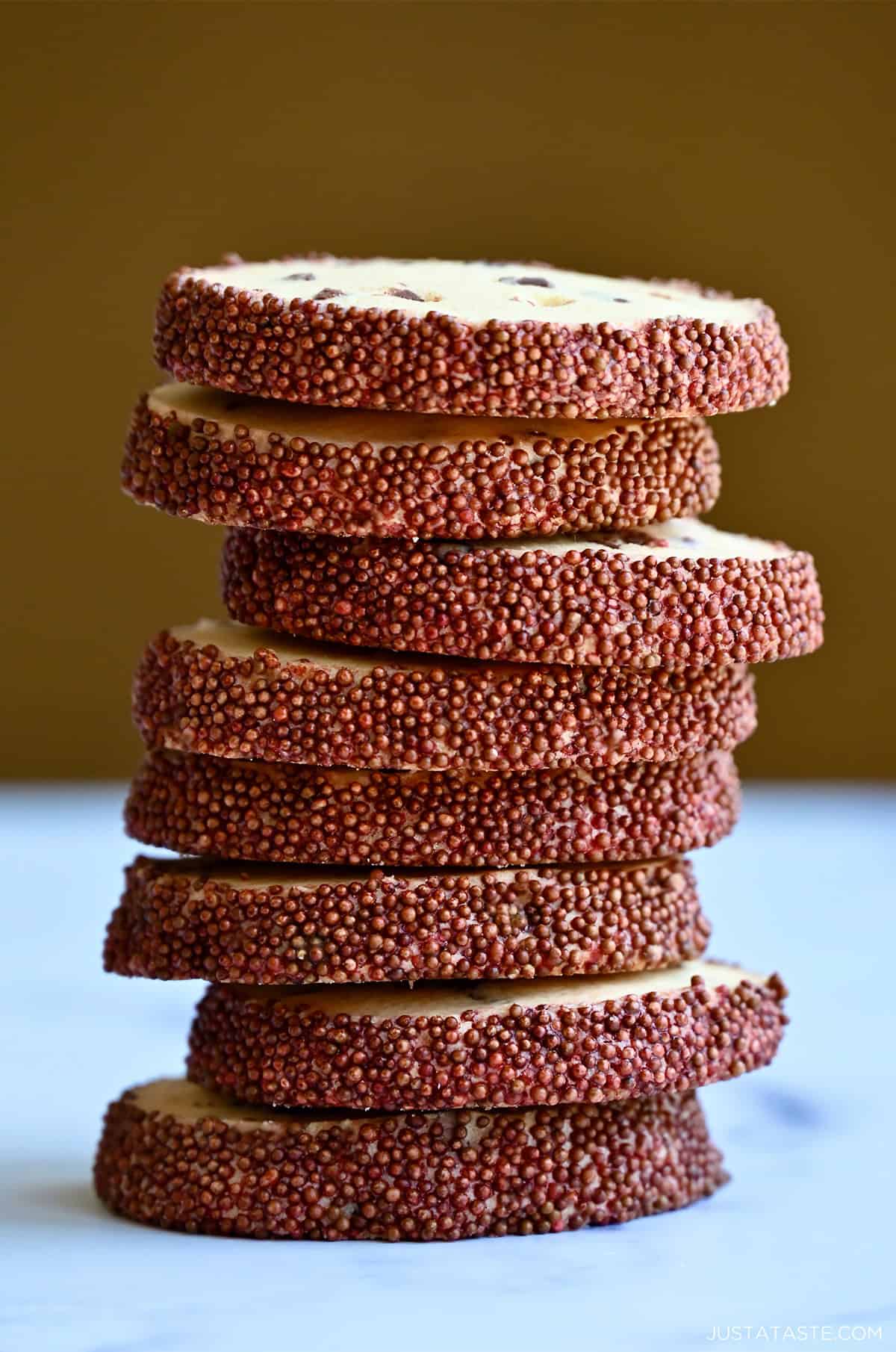 A tall stack of slice-and-bake chocolate chip cookies with a chocolate sprinkle edge.