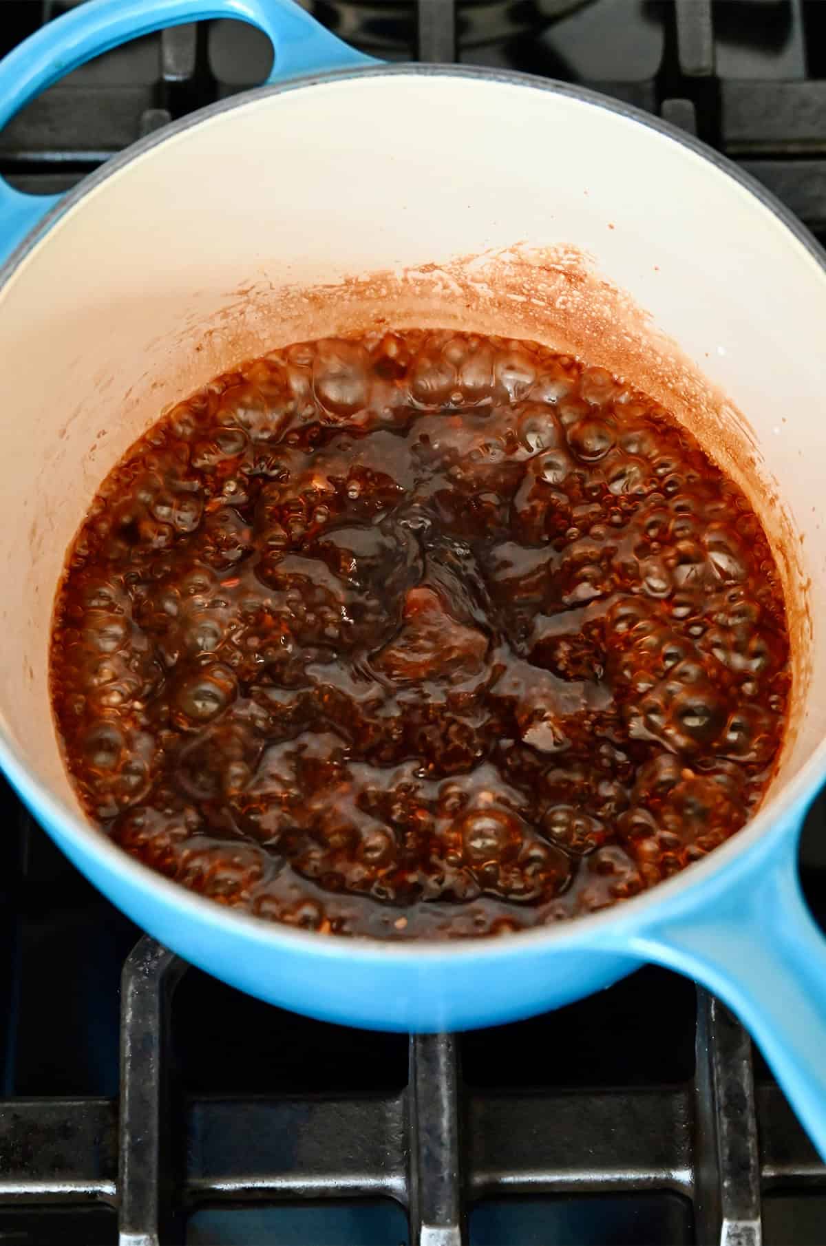 Bringing stir fry sauce to a boil in a small saucepan to thicken.